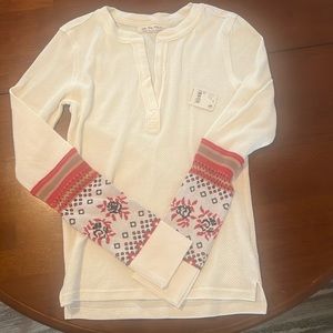 Cream color waffle v notch neck.  Lower half of sleeves are knit with pattern.